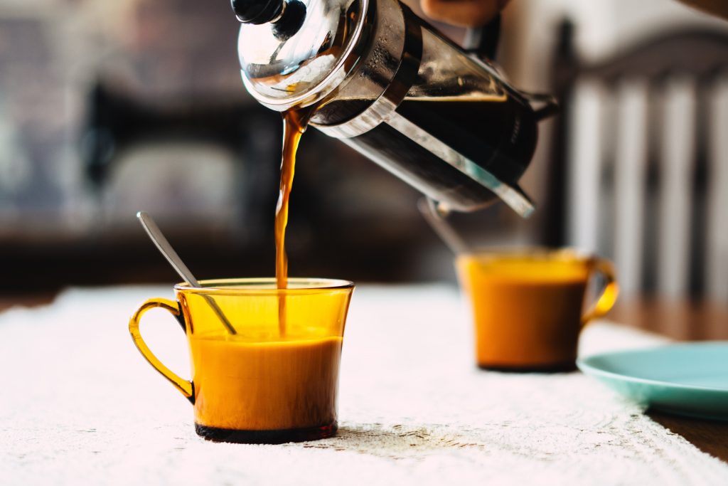 Image of a french press coffee machine pouring coffee.